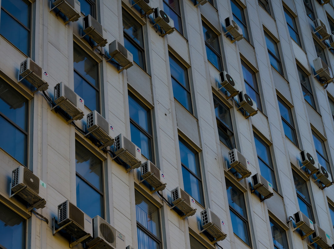 A tall building with lots of windows and a clock