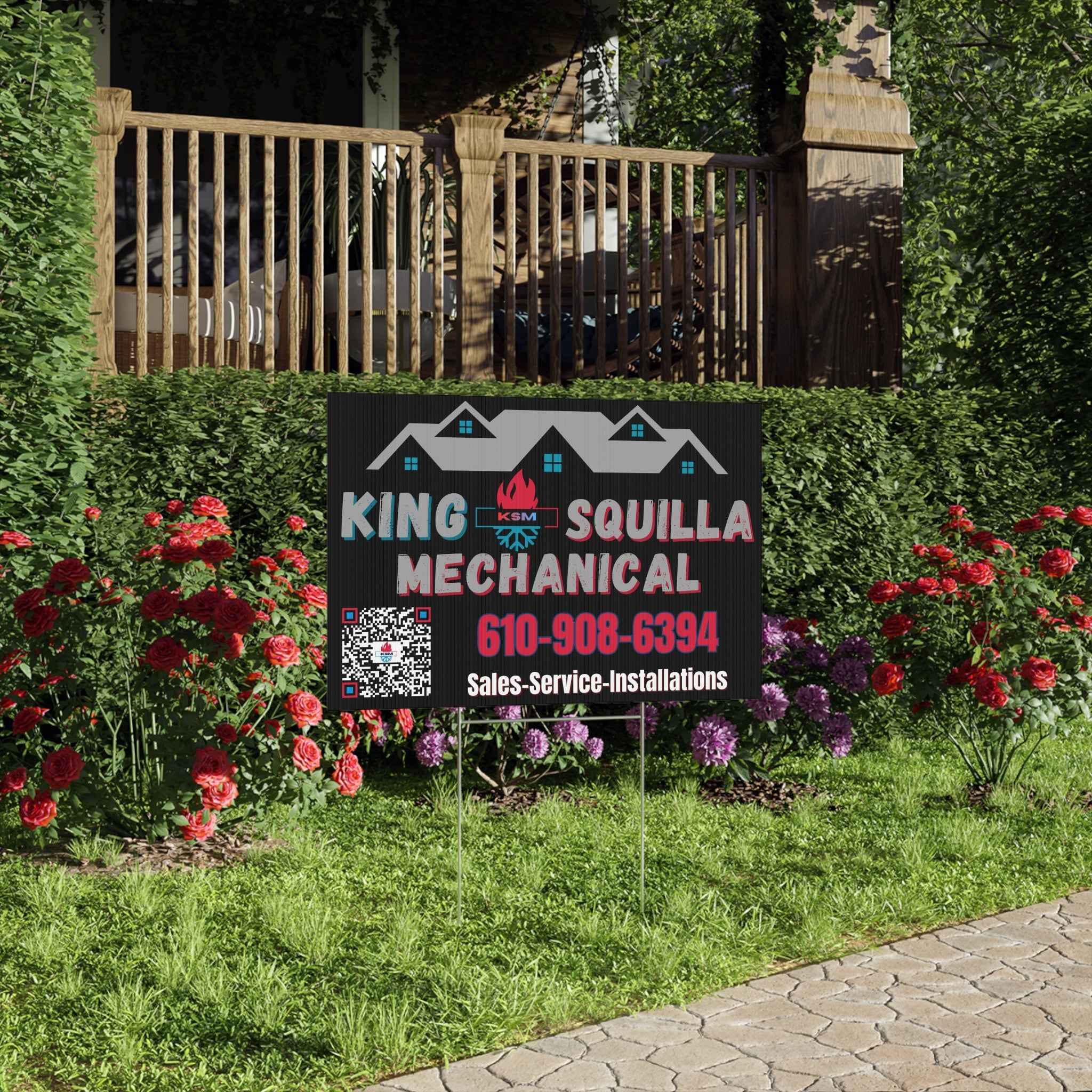 King Squilla Mechanical sign in a garden with flowers and a house in the background